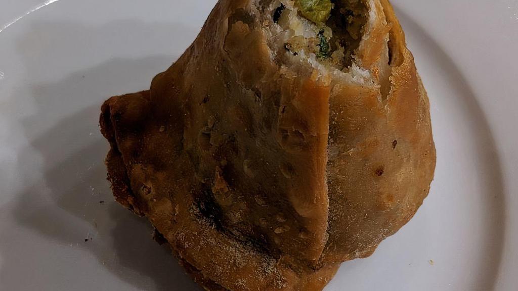 Vegetable Samosas · Lightly spiced potatoes and peas wrapped in pastry dough and deep fried (2 per order)