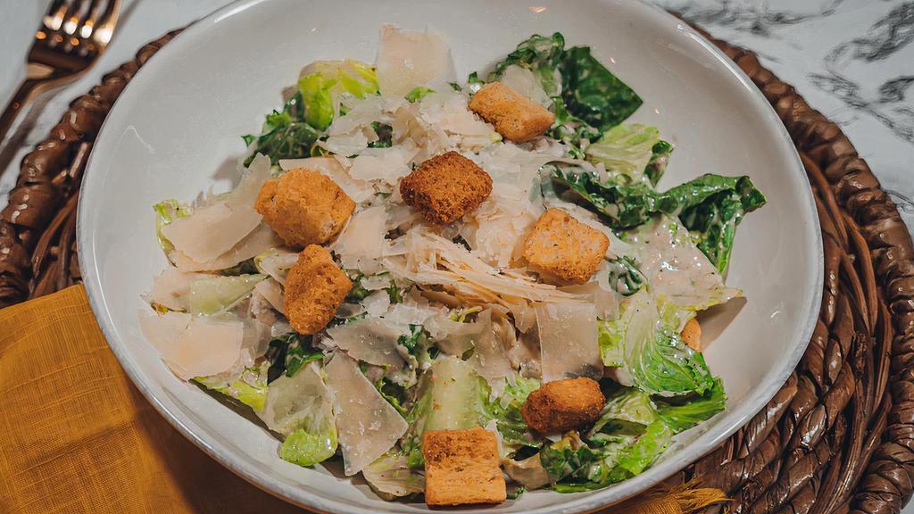 Caesar Salad · Romaine lettuce with caesar dressing croutons and parmesan.