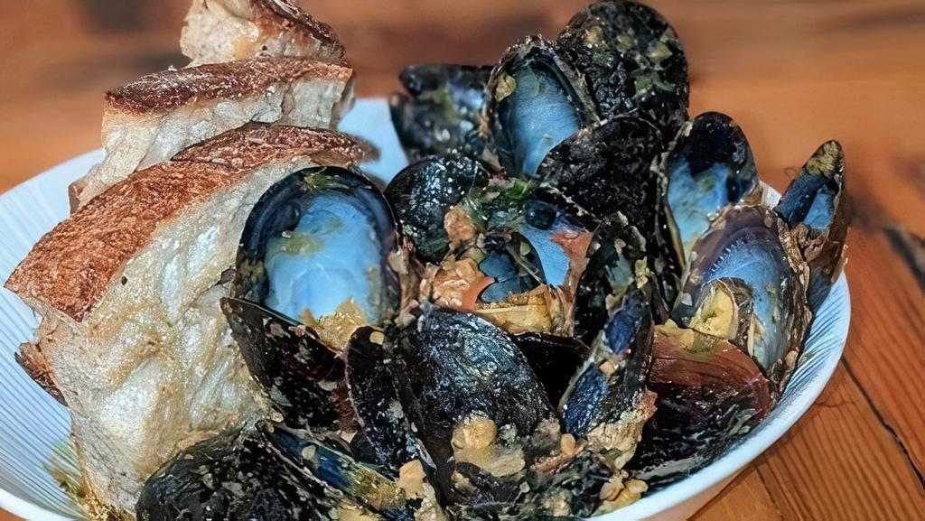 Sicillian Mussels · roasted tomatoes and garbanzo bean pesto,  calabrian chile, grilled bread