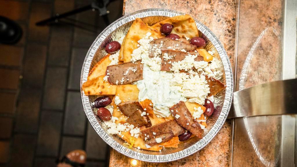 Pita Chips Platter · Pita bread wedges topped with gyro meat, tzatziki, feta cheese and olives.