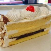 Italian Rum Cake Slice  · Yellow Cake, Chocolate Pudding, Vanilla Pudding, Rum, Whipped Cream, Sliced Almonds