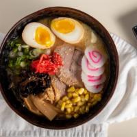 Miso Ramen · Our tonkotsu broth miso flavored noodle soup topped with chashu pork boiled egg, menma, red ...