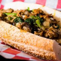 Vegan Cheesesteak · Seared seitan, chopped garlic, mushrooms, fried onions, Broccoli rabe, vegan mozzarella.