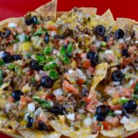 Nachos Con Carne · Tortilla chips covered in cheese, beef, olives, and pico de gallo.