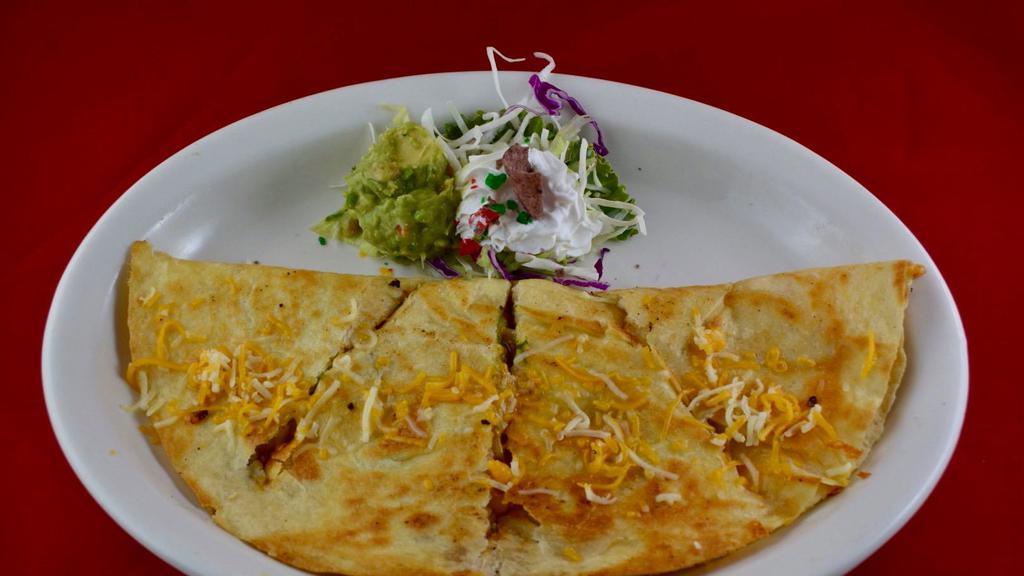 Quesadilla Cheese · Large flour tortilla filled with cheese.  Toppped with Guacamole and sour-cream.  Add beef, chicken or Veggies for $1.00