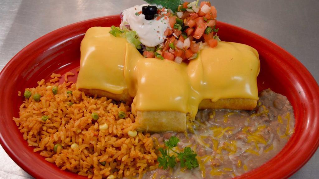 Pollo Fundido · Shredded chicken wrapped with a crispy flour tortilla. Topped with cream cheese and American cheese. Accompanied with a side of sour cream and pico de gallo.