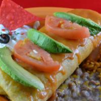 Deliciosa Seafood Chimi · Deep-fried burrito with crab, scallops, shrimp, onions and rice. Garnished with sliced avoca...