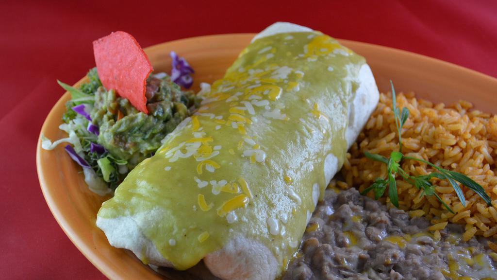 Burrito De Carne Asada · A soft burrito filled with rice, grilled steak with cheese. Covered in green sauce, and topped with guacamole.