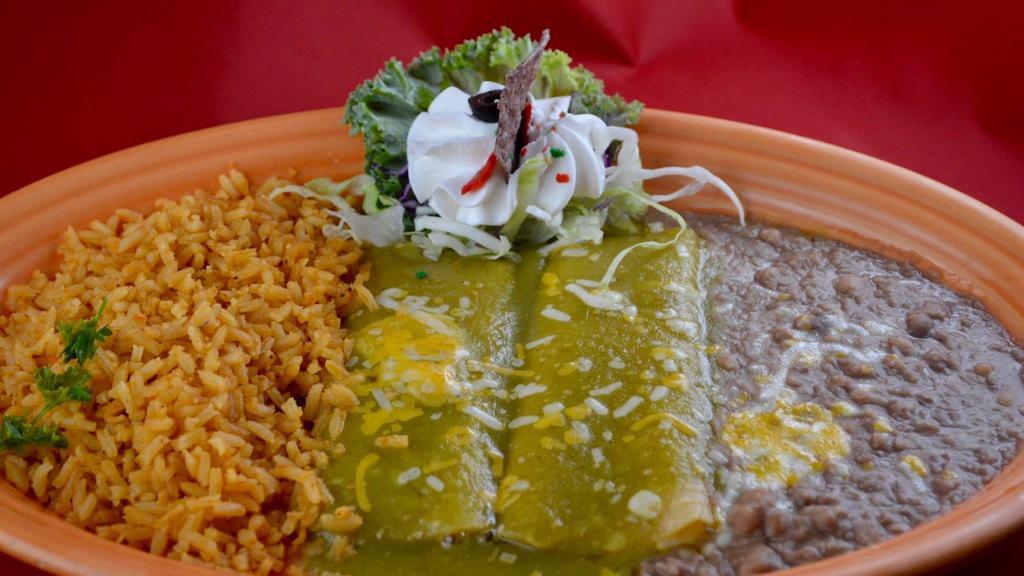 Enchiladas Verdes · Your choice of cheese, chicken or beef covered in tomatillo sauce and melted cheese. Garnished with sour cream. Our house specials include rice and beans.