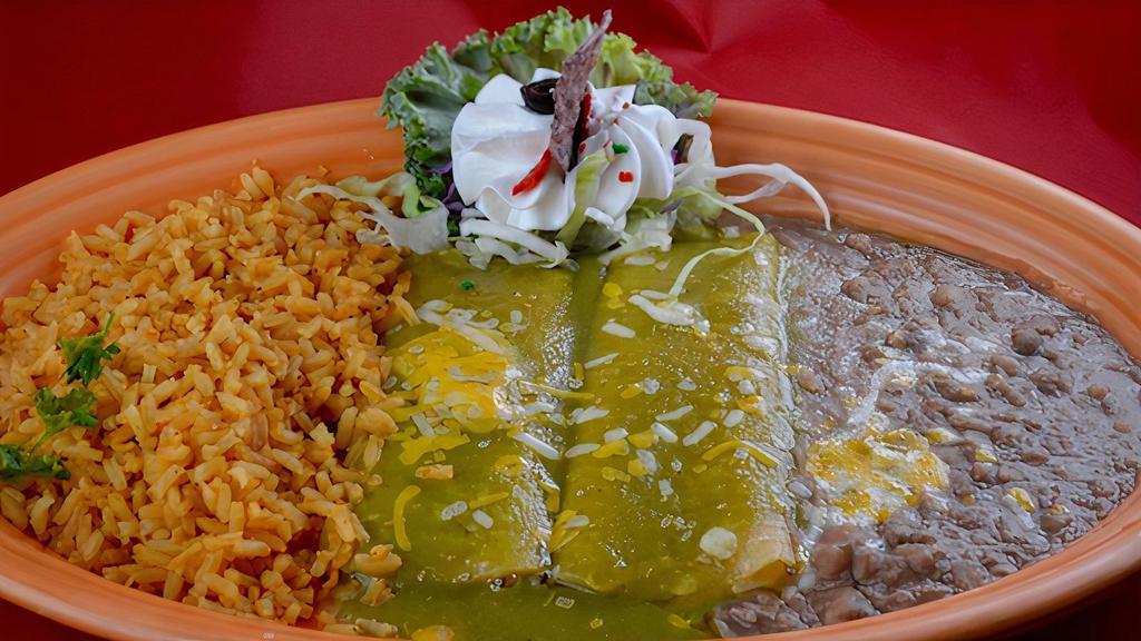 Spinach Enchiladas Dnr · 2 corn tortillas filled with spinach, tomato, and onions. Garnished with green sauce and sour cream. Our house specials include rice and beans.