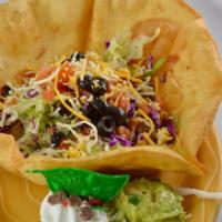 Tostada Grande · Giant tortilla shell with your choice of chicken or beef. Topped with cheese, olives, beans,...