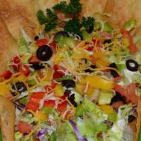 Taco Salad · Large tortilla shell filled with ground beef or ground chicken, onions, lettuce, green peppe...