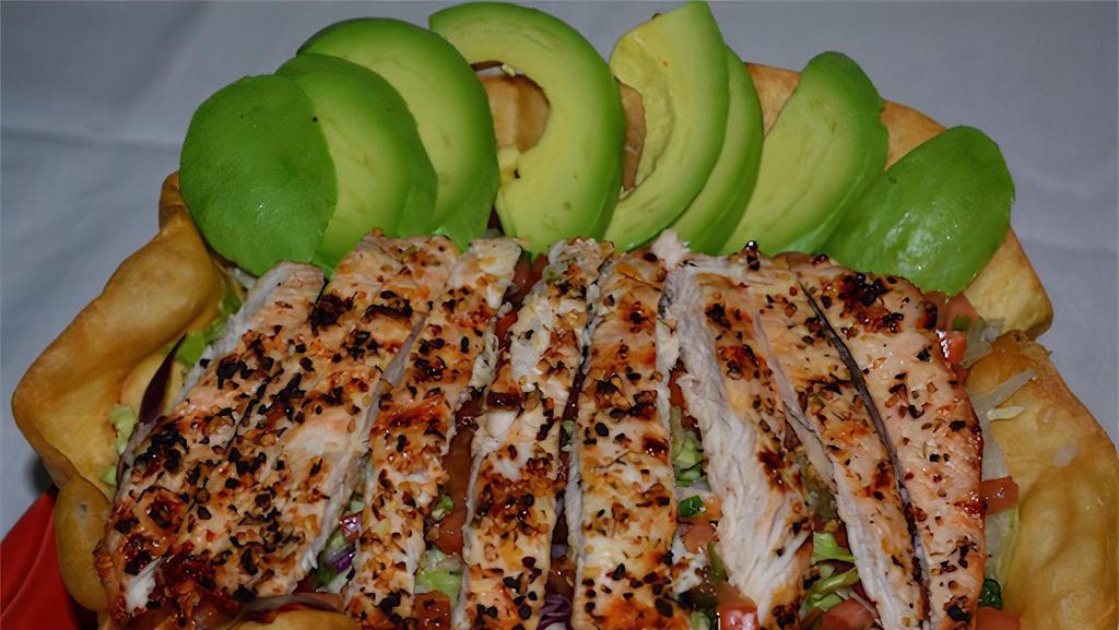 Ave Y Avocado Tostada · Charbroiled chicken breast. Filled with avocado, lettuce, black beans, rice, pico de gallo, and a sprinkle of corn tortilla chips.