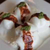 Dahi Bhalle · Velvety lentil dumplings in yogurt sauce topped with chutneys.