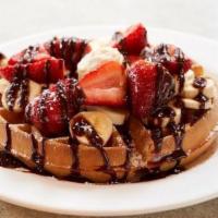 Waffle With Banana, Strawberries, Whipped Cream & Coffee Nutella Sauce  · Served with powdered sugar and whipped butter.