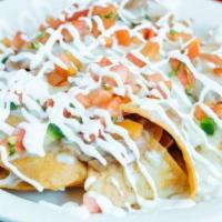 Nachos Grande · Home-made crispy corn tortilla chips pilled with beans and melted cheese. Topped with sour c...
