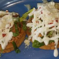 Sopes · 2 thick home-made corn tortillas deep fried smothered with beans topped with your choice of ...