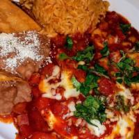 Huevos A La Mexicana · Scrambled eggs with tomato, onions and jalapenos. Served with Mexican rice, beans and corn t...