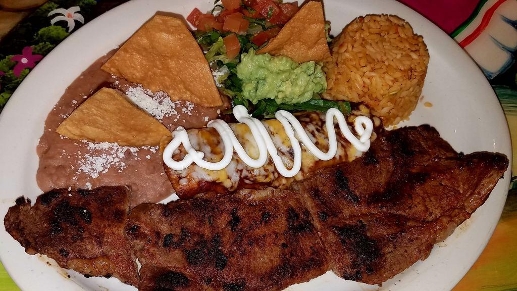 Carne A La Tampiqueña · Grilled steak with one chicken enchilada, guacamole, Mexican rice, beans and corn tortillas.