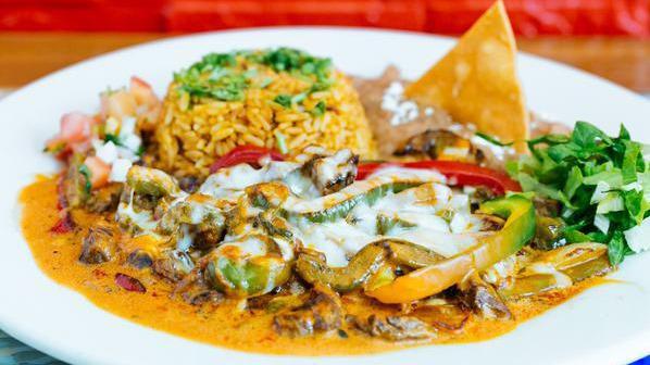 Puntas Con Nopales · Steak sautéed with chipotle sauce, onions, peppers, and nopales (cactuses) topped with melted cheese. Served with Mexican rice and beans.