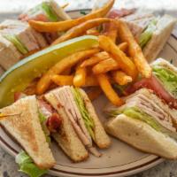 Turkey Club · Bacon, lettuce, and tomatoes. Served with French fries, mayonnaise, lettuce, tomato, colesla...