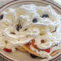 Red, White, And Blue · Your choice of French Toast, Hotcakes, or a Waffle. With strawberries, whipped cream, and bl...