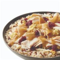 Thanksgiving Toasted · Hand-sliced Turkey, Stuffing, Cranberry Sauce and Mayonnaise and Hot Gravy over a bed of rice.