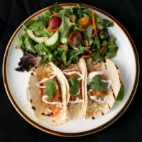 Fish Tacos · Fried fish on three flour tortillas with slaw, cilantro, lime, and guajillo chile.