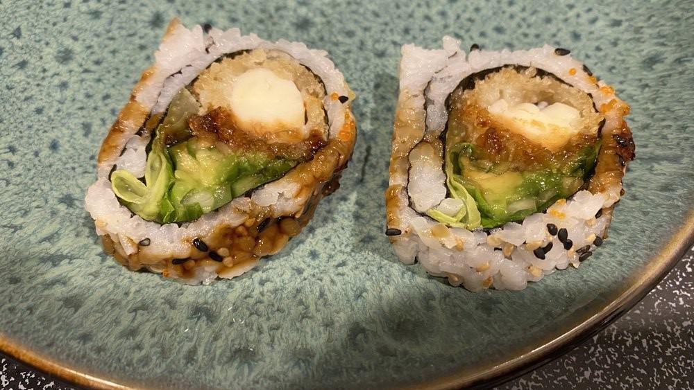 Lobster Tempura Roll · Deep fried lobster with avocado, lettuce cucumber and caviar outside.