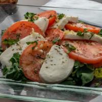 Caprese Salad · Fresh mozzarella, tomatoes, basil, garlic, and oil.