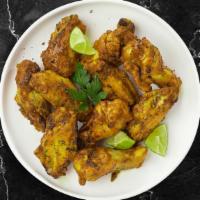 Johnny Lemon Pepper Wings · Fresh chicken wings , fried until golden brown, and tossed in lemon pepper sauce. Served wit...