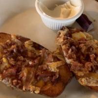 Potato Skins · Six crispy potato skins stuffed with cheddar, sour cream, and crispy bacon.