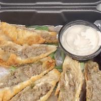 Philly Steak N’ Cheese Eggrolls · Crispy egg rolls stuffed with shaved steak, onions, peppers and lots of cheese, served with ...