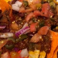 Loaded Nachos · Your choice of homemade chili or buffalo chicken. On tri-colored cooked to order nacho chips...
