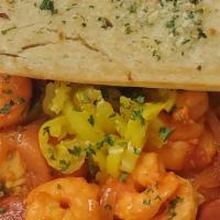 Portuguese Shrimp · A spicy treat! Sautéed shrimp with chourico, onions, and tomatoes finished in a Mozambique s...