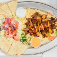 Combo Platter · Marinated beef, lamb, and chicken over rice or Moroccan couscous, served with a Greek salad,...