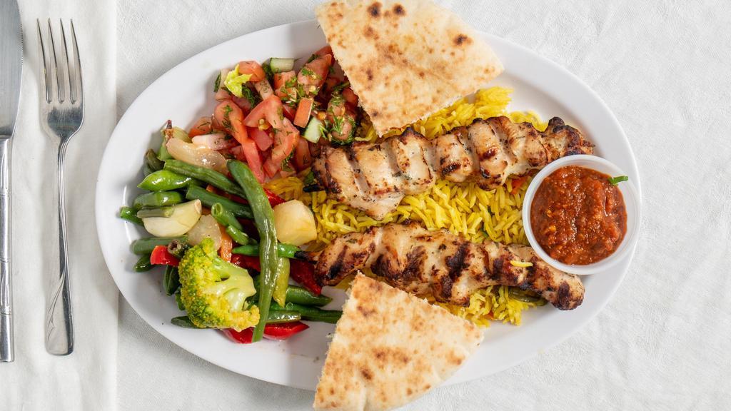 Shawarma Grilled Chicken Plate · Marinated grilled chicken over seasoned rice, Greek salad & homemade pita bread. Comes with tzatziki sauce and shawarma sauce.