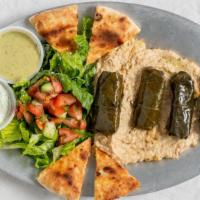 Hummus With Grape Leaves · Served with a side salad and homemade pita bread.