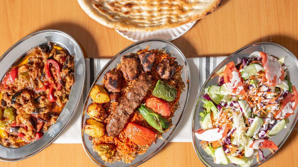 Chicken Kabob, Lamb Kabob, And Beef Kofta.  · 4 pieces of our chicken kabob, 4 pieces of our lamb kabob, and a half skewer of our beef kofta, served over kabuli rice, salad, choice of side & tandoori bread.  Made to order over a fire grill.