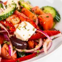 Horiatiki Village Salad · Tomato, red onions, red peppers, cucumbers, capers, Feta cheese, and olive. Dressed with oli...