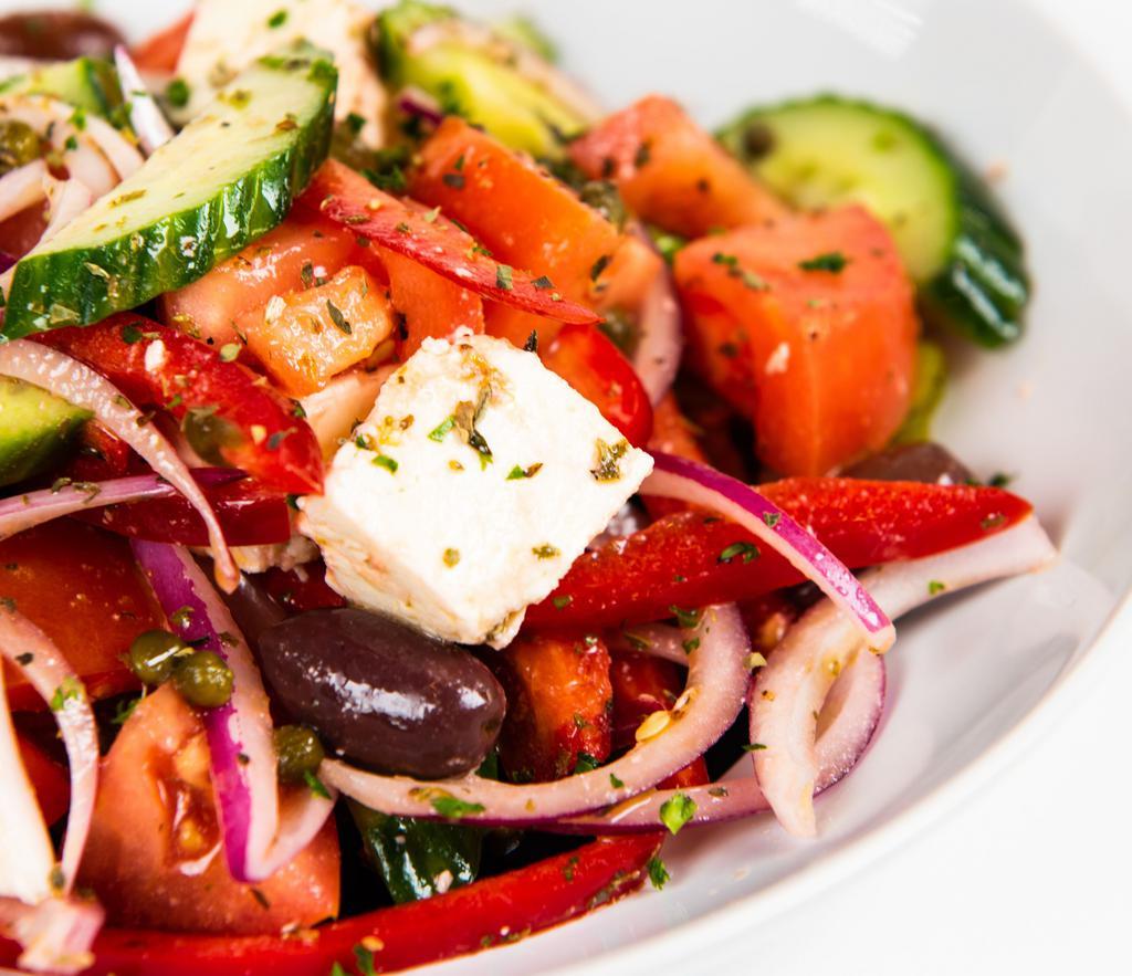 Horiatiki Village Salad · Tomato, red onions, red peppers, cucumbers, capers, Feta cheese, and olive. Dressed with olive oil and vinegar.