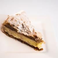 Baklava Cheesecake/House Cakes · Layers of baklava stuffed with cheesecake topped with powdered sugar.