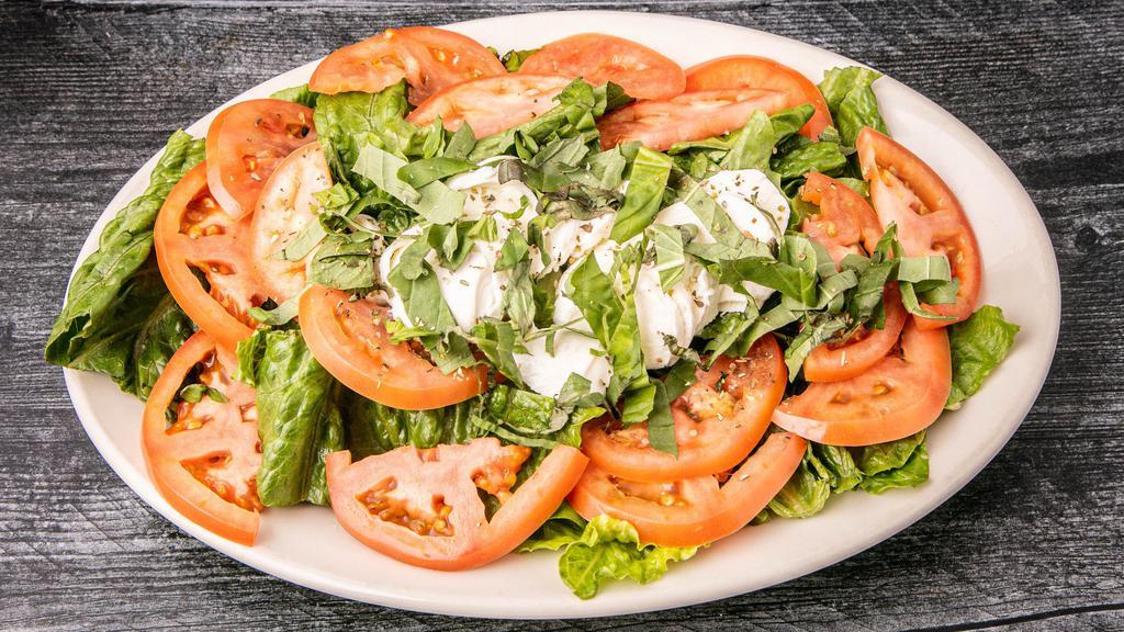 Caprese Salad · Fresh mozzarella, tomato, olive oil and balsamic vinegar, sprinkled with fresh basil and oregano on a bed of Romaine lettuce.