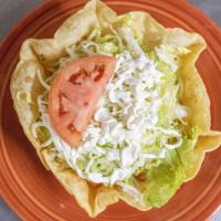 Taco Salad · Your choice of shredded chicken breast or ground beef in an edible taco shell bowl topped wi...