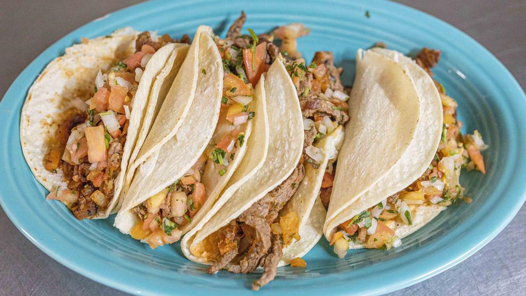 Tacos Azteca  · Four soft white corn tortilla tacos, Consisting of grilled steak Mexican sausage and pico de gallo, Served with refried beans