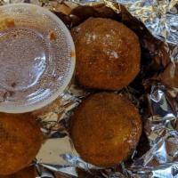 Arancini · Fried risotto balls stuffed with mozzarella and basil, served with marinara and a side salad...