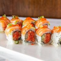 Beauty Alaskan Roll · Spicy salmon and cucumber rolled inside topped with salmon and avocado garnished with masago...