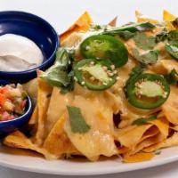 Cheese Nachos · fried corn tortillas topped with cheese, fresh jalapenos, and cilantro. Salsa fresca and sou...