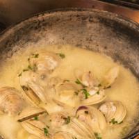 Steamed Chesapeake Clams · middle neck clams steamed in wine, parsley, spice + butter, served with garlic toasts
