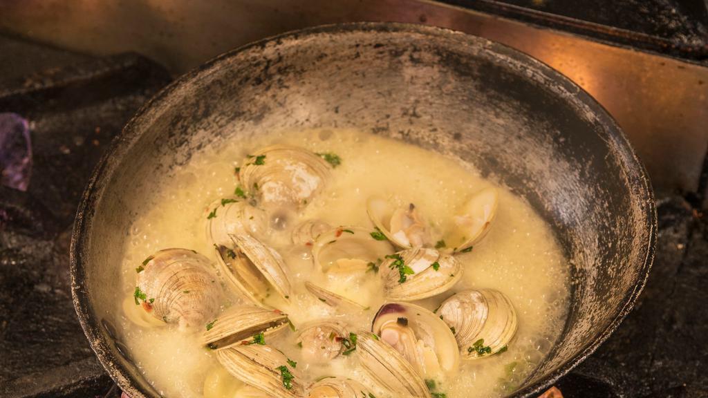 Steamed Chesapeake Clams · middle neck clams steamed in wine, parsley, spice + butter, served with garlic toasts